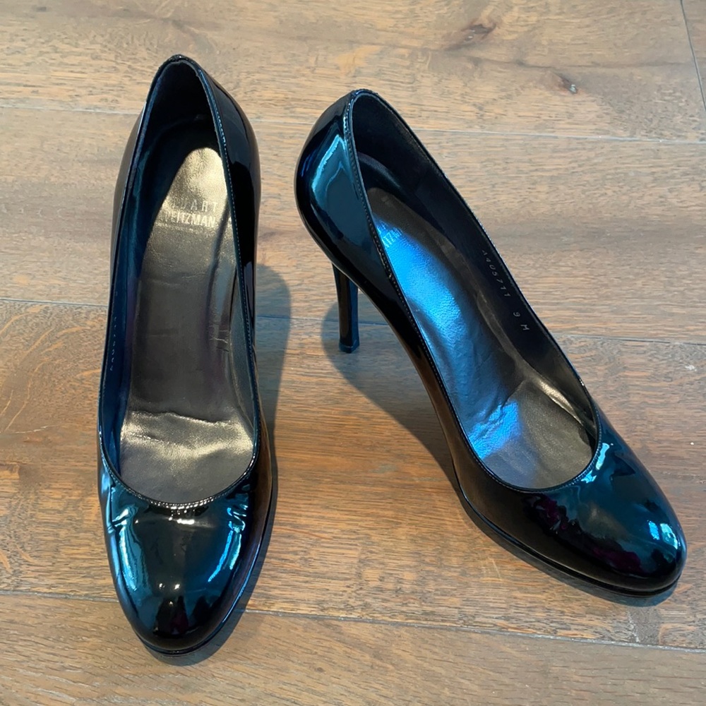 Stuart Weitzman black patent pump with a small platform.